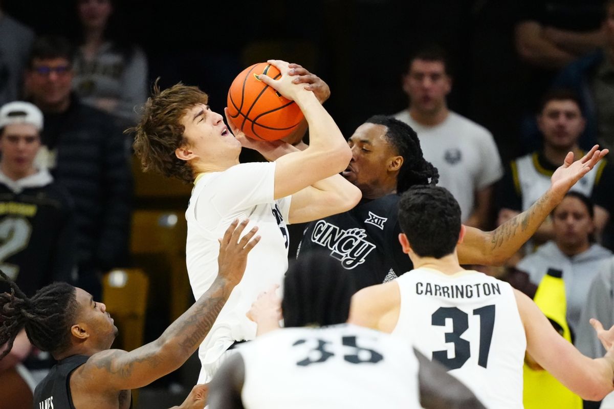 Jan 15, 2025; Boulder, Colorado, USA; Cincinnati Bearcats guard Day Day Thomas (1) collides into Colorado Buffaloes forward Sebastian Rancik (7) in the first half at the CU Events Center. Mandatory Credit: Ron Chenoy-Imagn Images