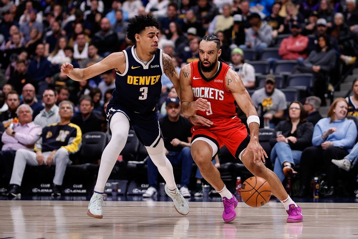Jan 15, 2025; Denver, Colorado, USA; Houston Rockets forward Dillon Brooks (9) controls the ball as Denver Nuggets guard Julian Strawther (3) guards in the first quarter at Ball Arena. Mandatory Credit: Isaiah J. Downing-Imagn Images