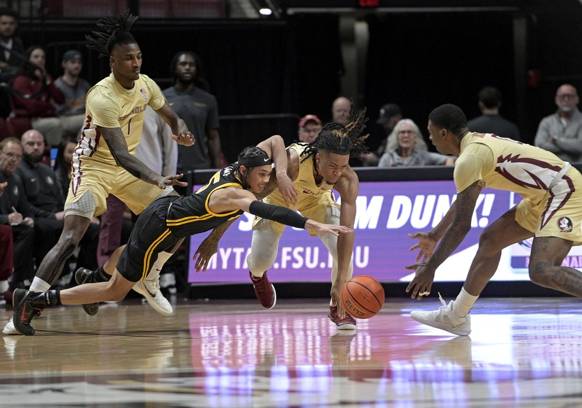 Jan 15, 2025; Tallahassee, Florida, USA; Florida State Seminoles guard DaQuan Davis (5) and Pittsburgh Panthers guard Jaland Lowe (15) dive for a loose ball during the first half at Donald L. Tucker Center. Mandatory Credit: Melina Myers-Imagn Images