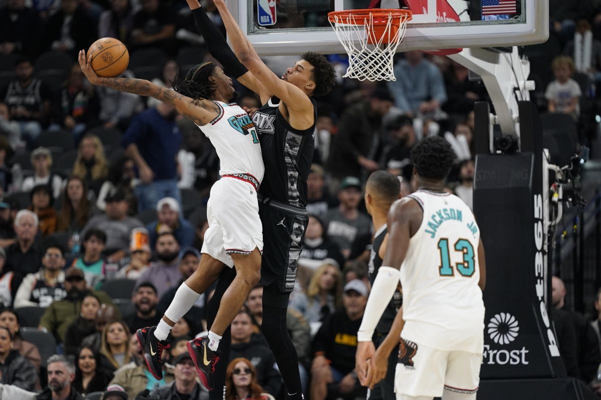 Jan 15, 2025; San Antonio, Texas, USA; Memphis Grizzlies guard Ja Morant (12) shoots against San Antonio Spurs center center Victor Wembanyama (1) during the second half at Frost Bank Center. Mandatory Credit: Scott Wachter-Imagn Images