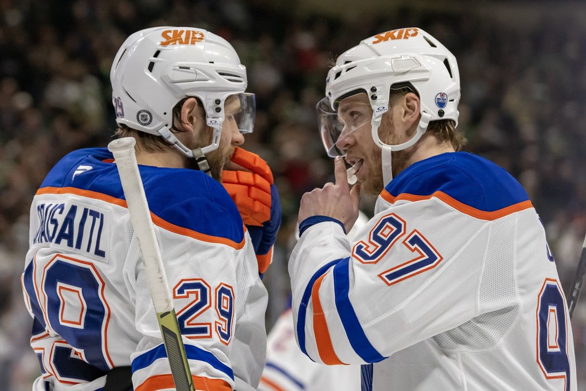 Jan 15, 2025; Saint Paul, Minnesota, USA;  Edmonton Oilers forward Leon Draisaitl (29) and forward Connor McDavid (97) talk before a face-off against the Minnesota Wild during the third period at Xcel Energy Center. Mandatory Credit: Nick Wosika-Imagn Images