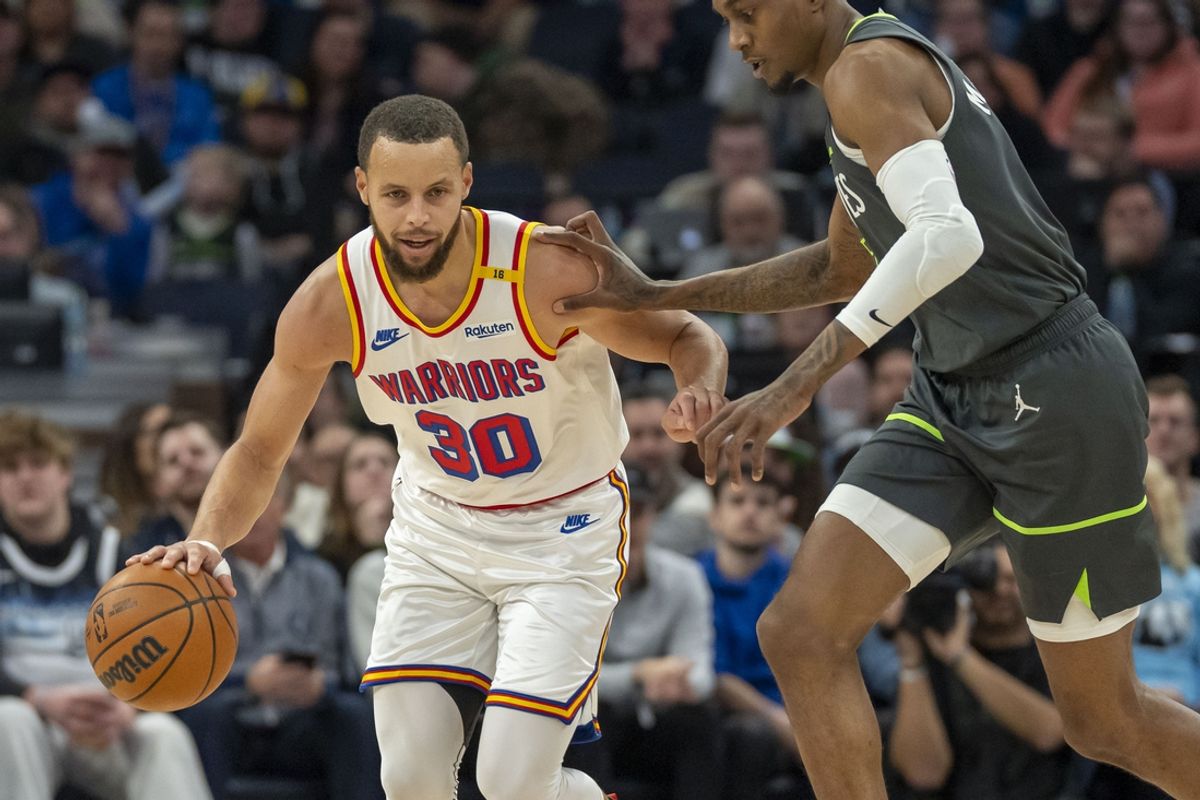 Jan 15, 2025; Minneapolis, Minnesota, USA; Golden State Warriors guard Stephen Curry (30) dribbles the ball up the court past Minnesota Timberwolves forward Jaden McDaniels (3) in the second half at Target Center. Mandatory Credit: Jesse Johnson-Imagn Images