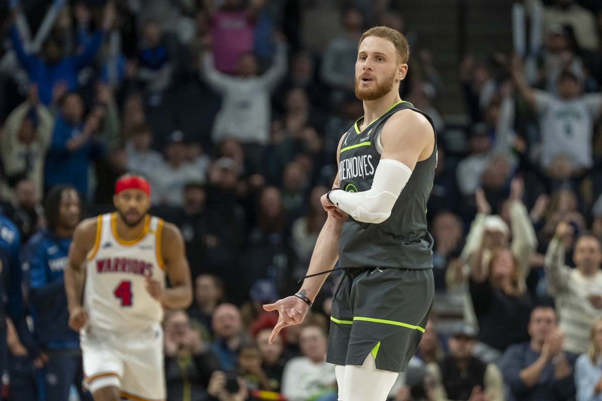 Jan 15, 2025; Minneapolis, Minnesota, USA; Minnesota Timberwolves guard Donte DiVincenzo (0) celebrates after making a three point shot against the Golden State Warriors at Target Center. Mandatory Credit: Jesse Johnson-Imagn Images