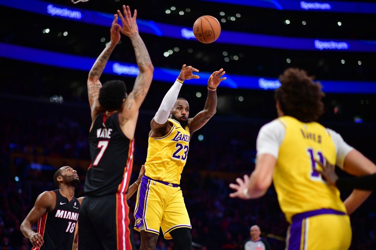 January 15, 2025; Los Angeles, California, USA; Los Angeles Lakers forward LeBron James (23) passes against the defense of Miami Heat center Kel'el Ware (7) during the second half at Crypto.com Arena. Mandatory Credit: Gary A. Vasquez-Imagn Images