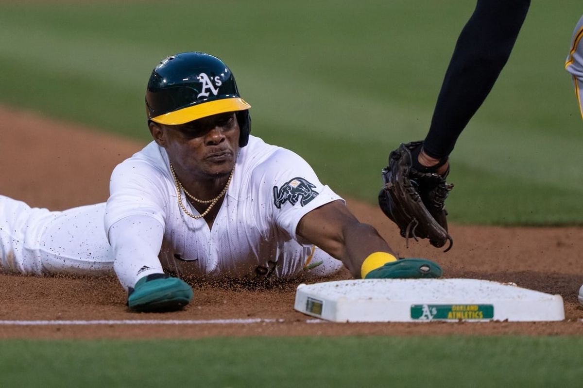 Apr 29, 2024; Oakland, California, USA; Oakland Athletics outfielder Esteury Ruiz (1) slides into third base during the fifth inning against Pittsburgh Pirates third base Ke'Bryan Hayes (13) at Oakland-Alameda County Coliseum.