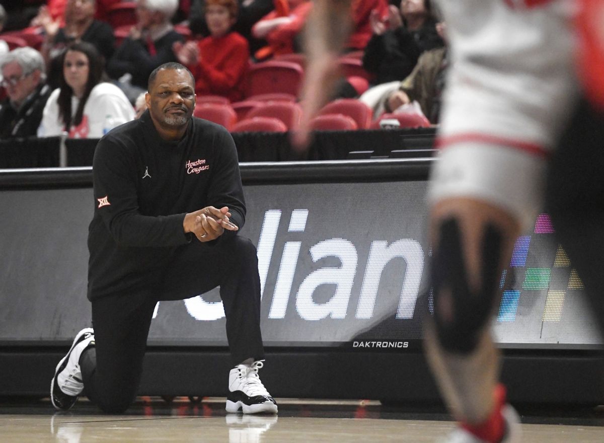 Houston women's basketball coach Ronald Hughey kneels on the sidelines during the Big 12 game against Texas Tech, Wednesday, Jan. 24, 2024, at United Supermarkets Arena.