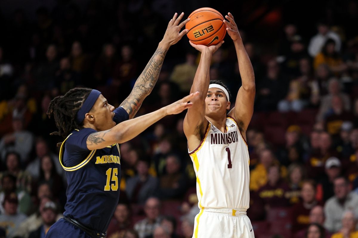 Jan 16, 2025; Minneapolis, Minnesota, USA; Minnesota Golden Gophers guard Isaac Asuma (1) shoots as Michigan Wolverines guard Rubin Jones (15) defends during the first half at Williams Arena. Mandatory Credit: Matt Krohn-Imagn Images