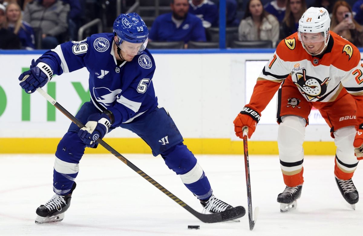 Jan 16, 2025; Tampa, Florida, USA; Tampa Bay Lightning center Jake Guentzel (59) skates with the puck as Anaheim Ducks center Isac Lundestrom (21) defends during the first period at Amalie Arena. Mandatory Credit: Kim Klement Neitzel-Imagn Images