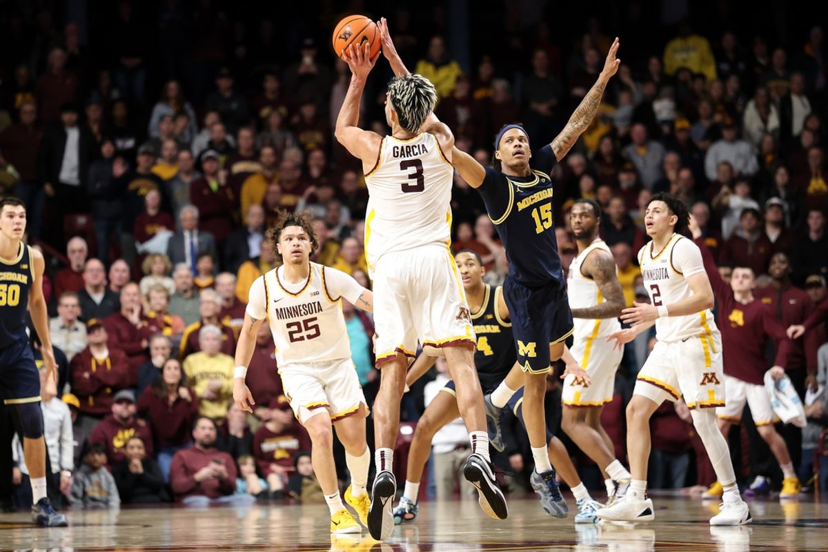 Jan 16, 2025; Minneapolis, Minnesota, USA; Minnesota Golden Gophers forward Dawson Garcia (3) shoots the game winning three-point basket as Michigan Wolverines guard Rubin Jones (15) defends during overtime at Williams Arena. Mandatory Credit: Matt Krohn-Imagn Images