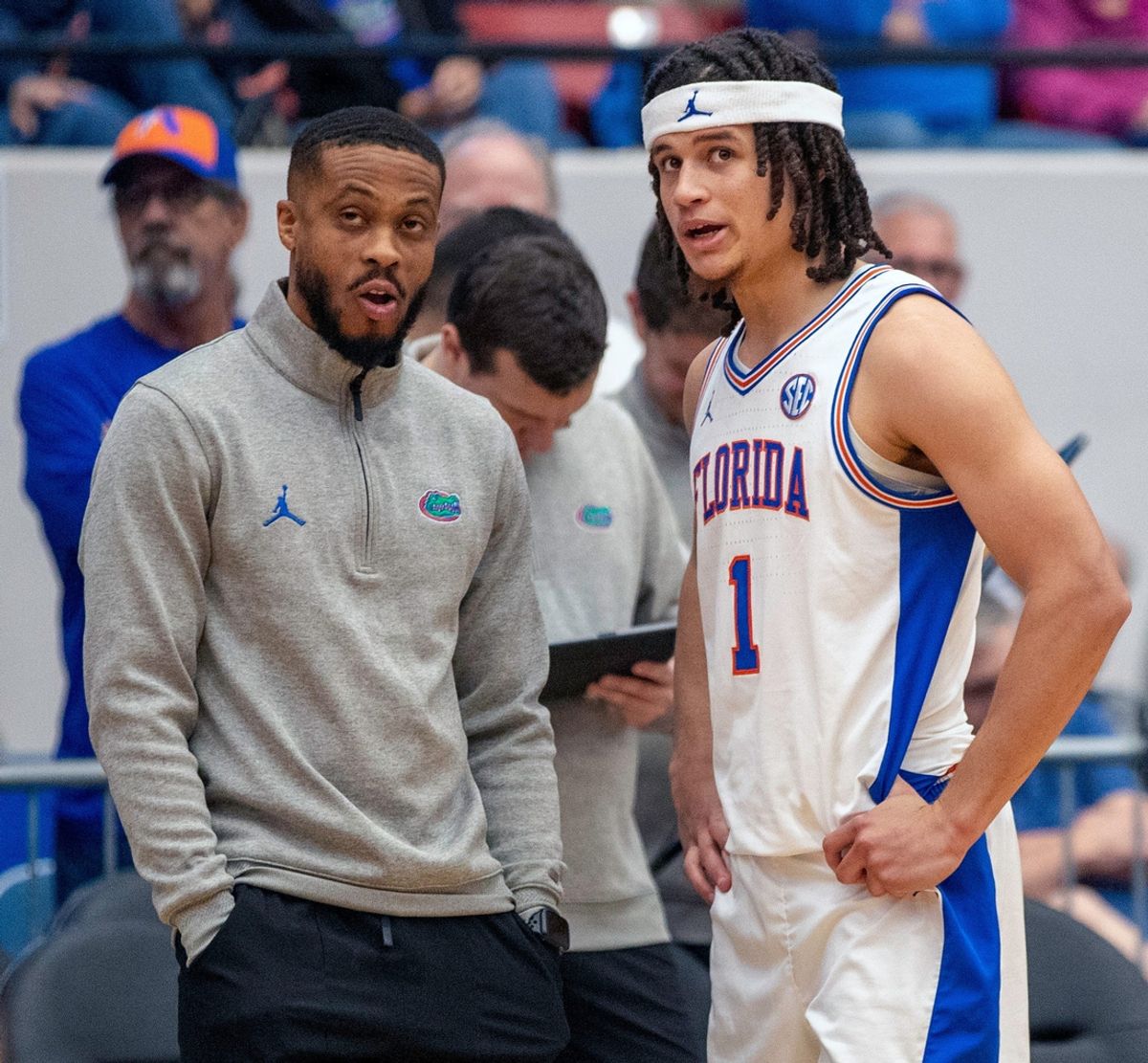Florida guard Walter Clayton Jr. talks to assistant coach Taurean Green prior to the second half against East Carolina on Dec. 14, 2023, at the RP Funding Center.