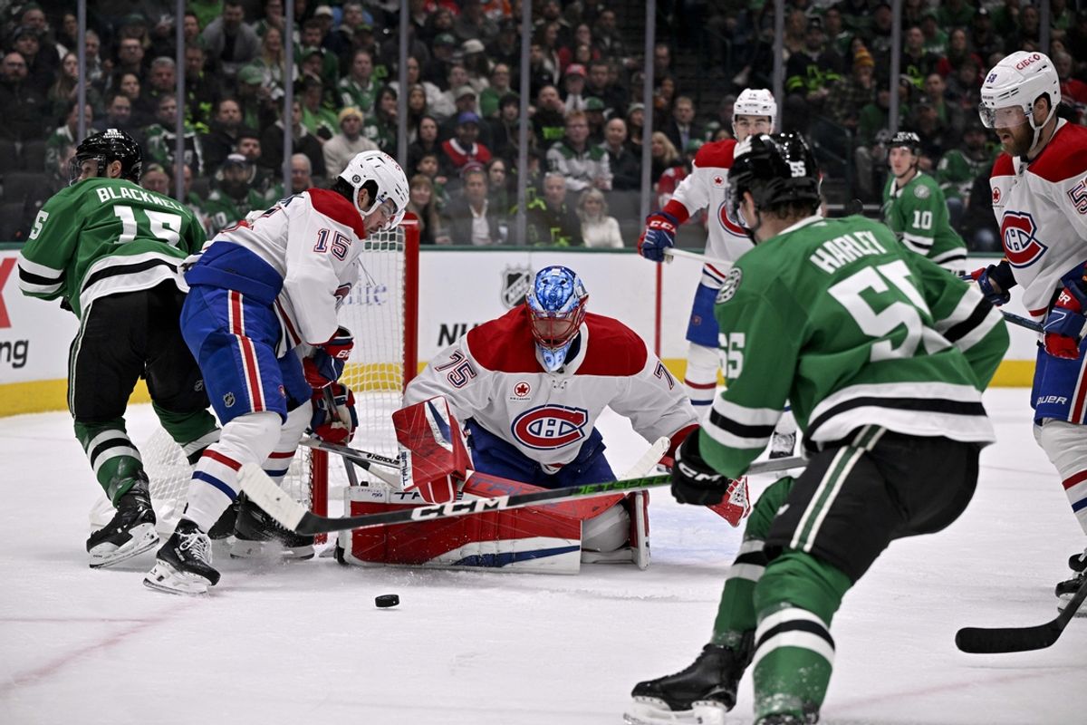 Jan 16, 2025; Dallas, Texas, USA; Montreal Canadiens goaltender Jakub Dobes (75) covers up the puck in front of Dallas Stars left wing Jamie Benn (14) and center Wyatt Johnston (53) during the second period at the American Airlines Center. Mandatory Credit: Jerome Miron-Imagn Images