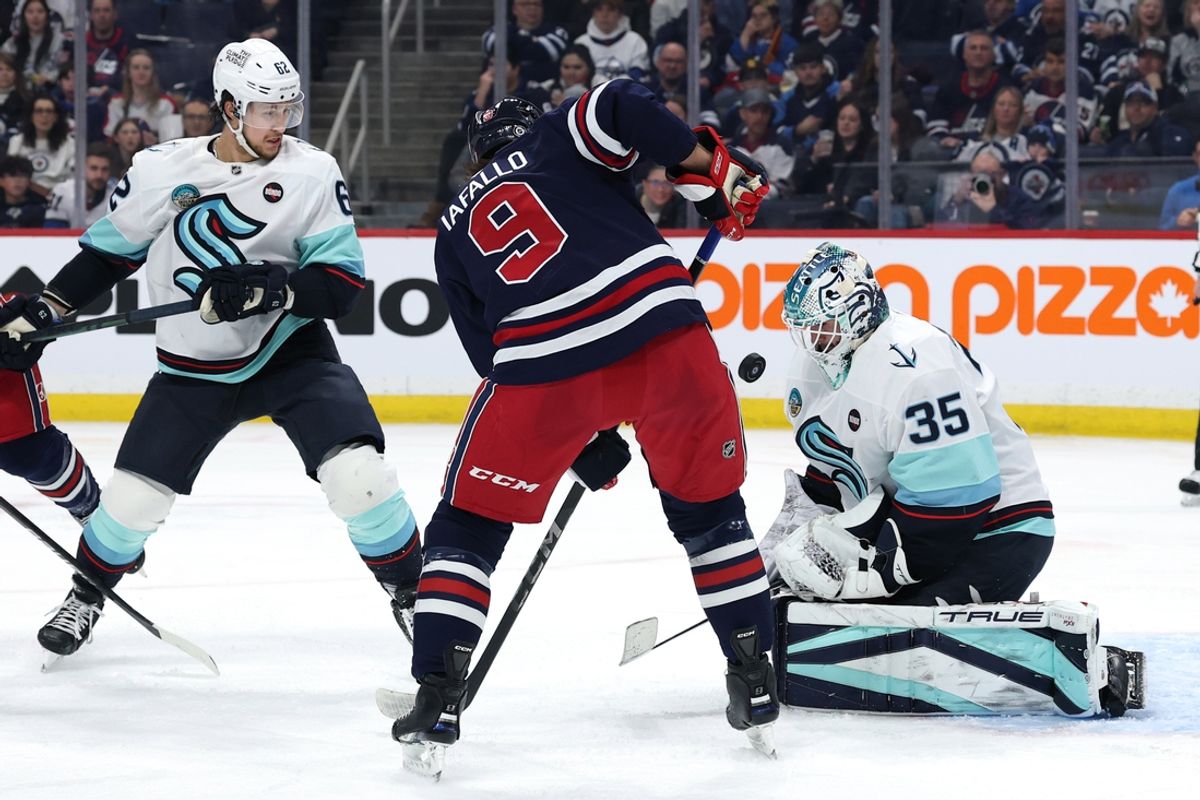 Jan 16, 2025; Winnipeg, Manitoba, CAN; Winnipeg Jets left wing Alex Iafallo (9) has his shot blocked by Seattle Kraken goaltender Joey Daccord (35) in the second period at Canada Life Centre. Mandatory Credit: James Carey Lauder-Imagn Images
