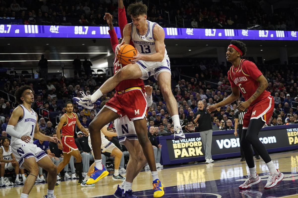 Jan 16, 2025; Evanston, Illinois, USA; Northwestern Wildcats guard Brooks Barnhizer (13) grabs a rebound against the Maryland Terrapins during the first half  at Welsh-Ryan Arena. Mandatory Credit: David Banks-Imagn Images