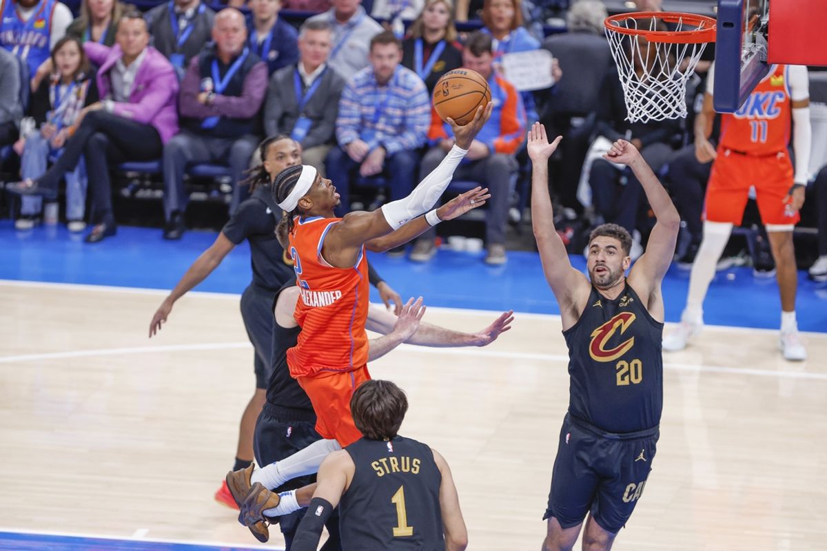 Jan 16, 2025; Oklahoma City, Oklahoma, USA; Oklahoma City Thunder guard Shai Gilgeous-Alexander (2) goes to the basket between Cleveland Cavaliers forward Georges Niang (20) and guard Max Strus (1) during the fourth quarter at Paycom Center. Mandatory Credit: Alonzo Adams-Imagn Images