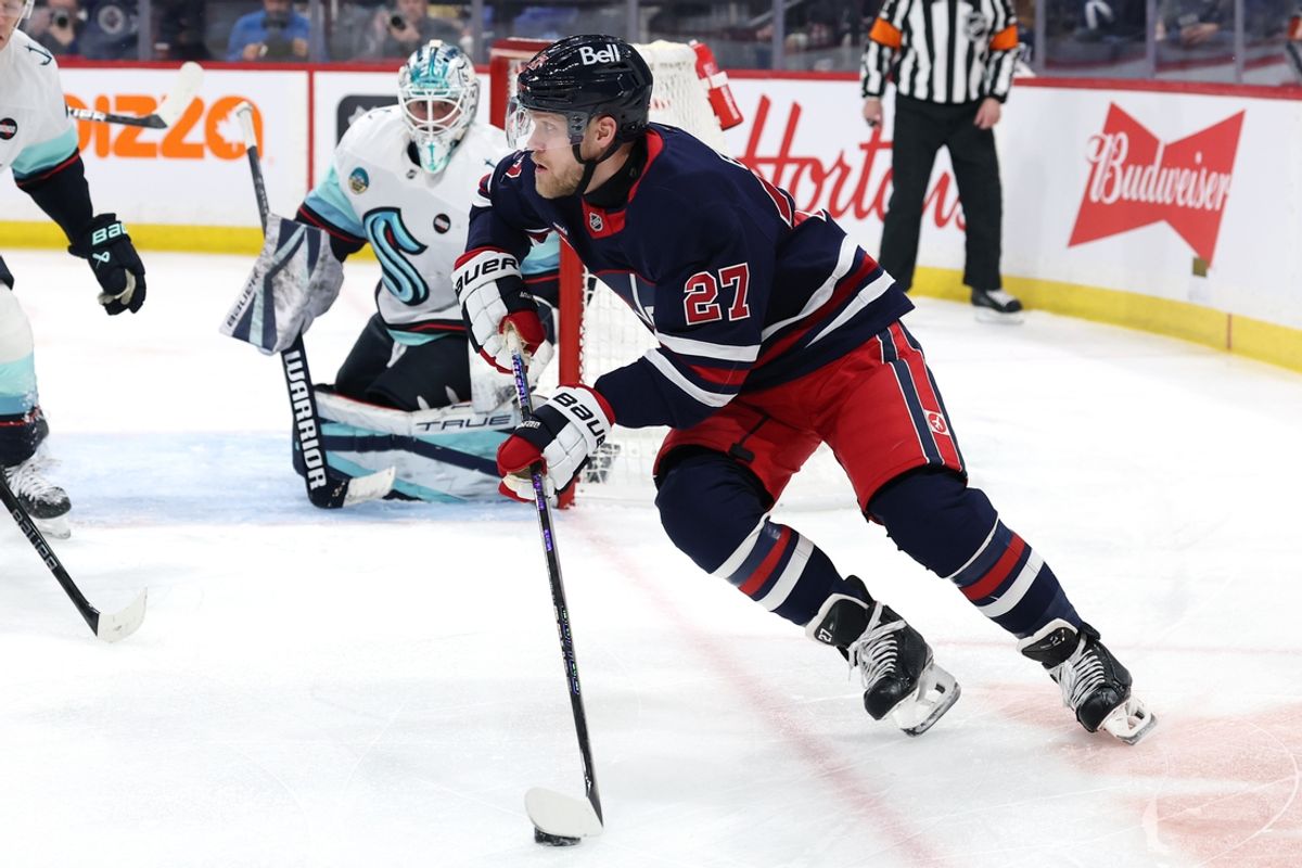Jan 16, 2025; Winnipeg, Manitoba, CAN; Winnipeg Jets left wing Nikolaj Ehlers (27) skates around Seattle Kraken goaltender Joey Daccord (35) in the second period at Canada Life Centre. Mandatory Credit: James Carey Lauder-Imagn Images