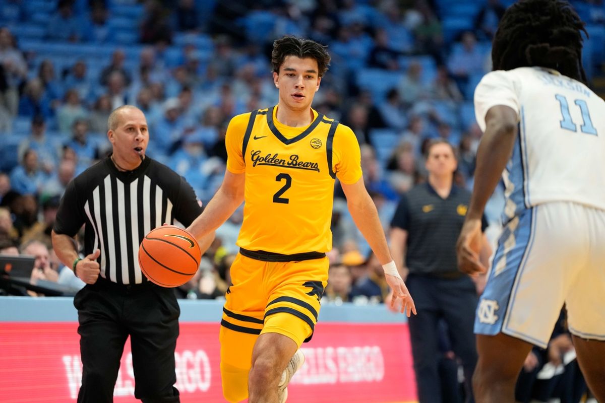 Jan 15, 2025; Chapel Hill, North Carolina, USA; California Golden Bears guard Andrej Stojakovic (2) dribbles as North Carolina Tar Heels guard Ian Jackson (11) defends in the first half at Dean E. Smith Center. Mandatory Credit: Bob Donnan-Imagn Images