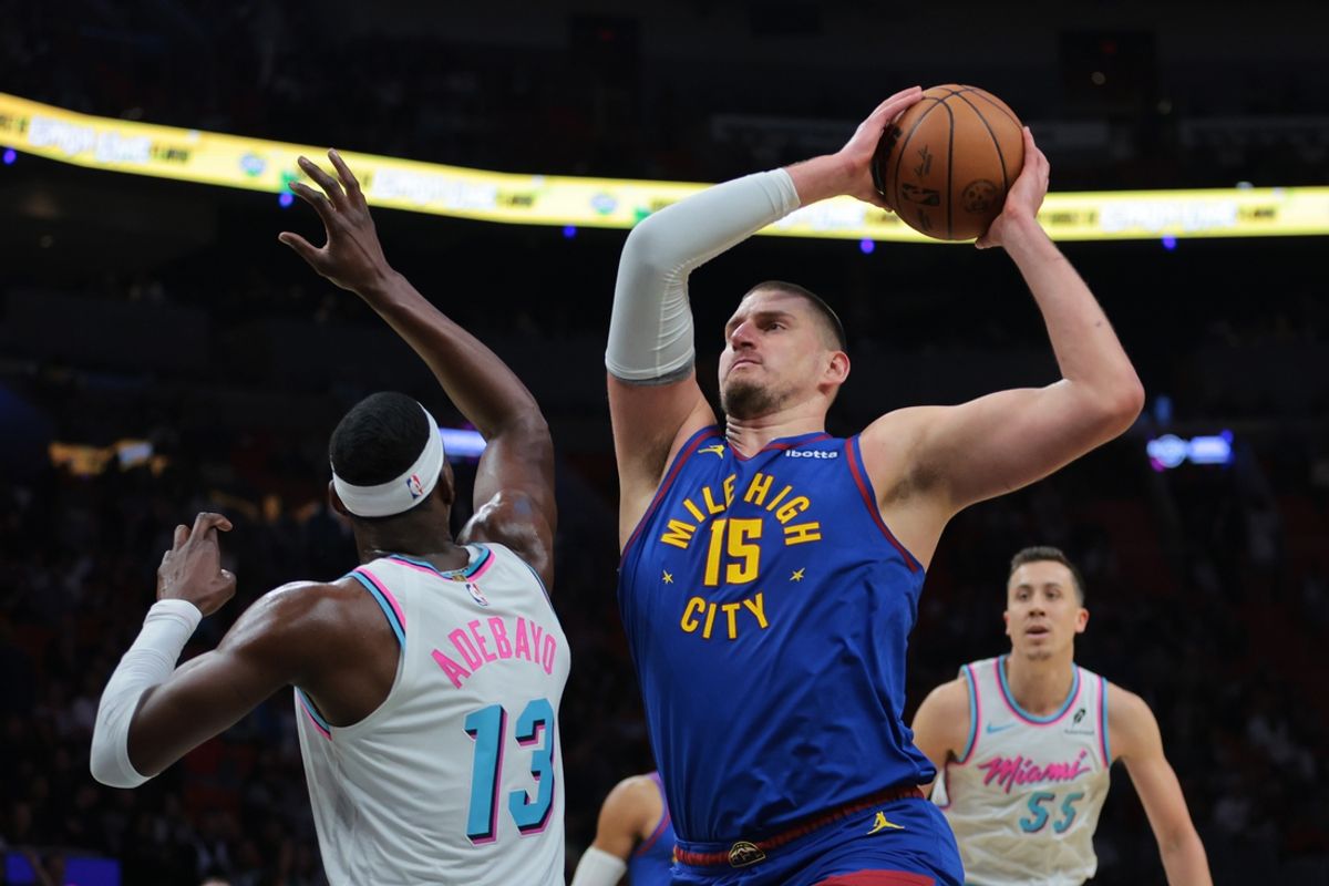 Jan 17, 2025; Miami, Florida, USA; Denver Nuggets center Nikola Jokic (15) drives to the basket against Miami Heat center Bam Adebayo (13) during the first quarter at Kaseya Center. Mandatory Credit: Sam Navarro-Imagn Images