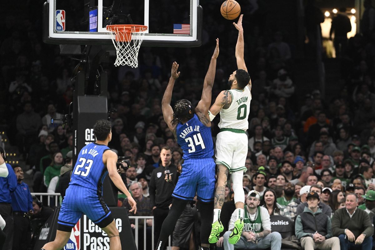 Jan 17, 2025; Boston, Massachusetts, USA; Boston Celtics forward Jayson Tatum (0) shoots over Orlando Magic center Wendell Carter Jr. (34) during the first half at TD Garden. Mandatory Credit: Eric Canha-Imagn Images