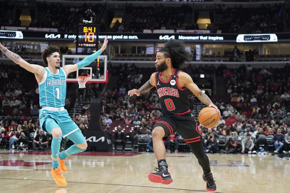 Jan 17, 2025; Chicago, Illinois, USA; Charlotte Hornets guard LaMelo Ball (1) defends Chicago Bulls guard Coby White (0) during the first quarter at United Center. Mandatory Credit: David Banks-Imagn Images