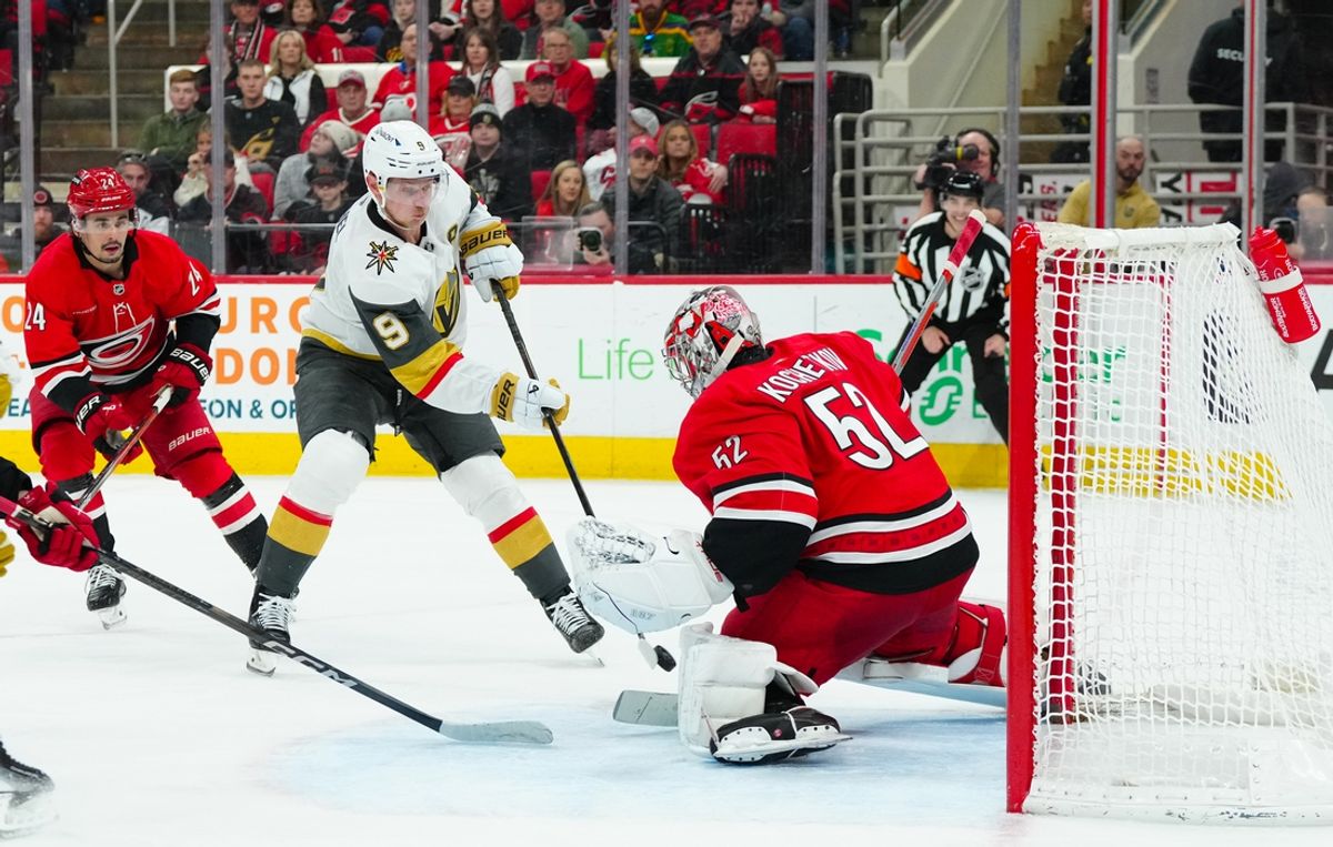 Jan 17, 2025; Raleigh, North Carolina, USA; Carolina Hurricanes goaltender Pyotr Kochetkov (52) stops the shot attempt by Vegas Golden Knights center Jack Eichel (9) during the second period at Lenovo Center. Mandatory Credit: James Guillory-Imagn Images