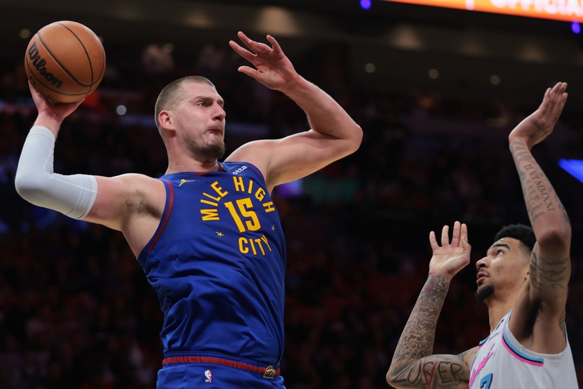Jan 17, 2025; Miami, Florida, USA; Denver Nuggets center Nikola Jokic (15) protects the basketball from Miami Heat center Kel'el Ware (7) during the first quarter at Kaseya Center. Mandatory Credit: Sam Navarro-Imagn Images