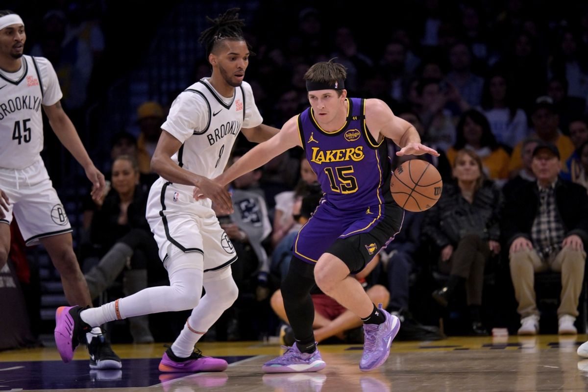 Jan 17, 2025; Los Angeles, California, USA;  Los Angeles Lakers forward Cam Reddish (5) controls the ball away from Brooklyn Nets forward Ziaire Williams (8) in the first half at Crypto.com Arena. Mandatory Credit: Jayne Kamin-Oncea-Imagn Images