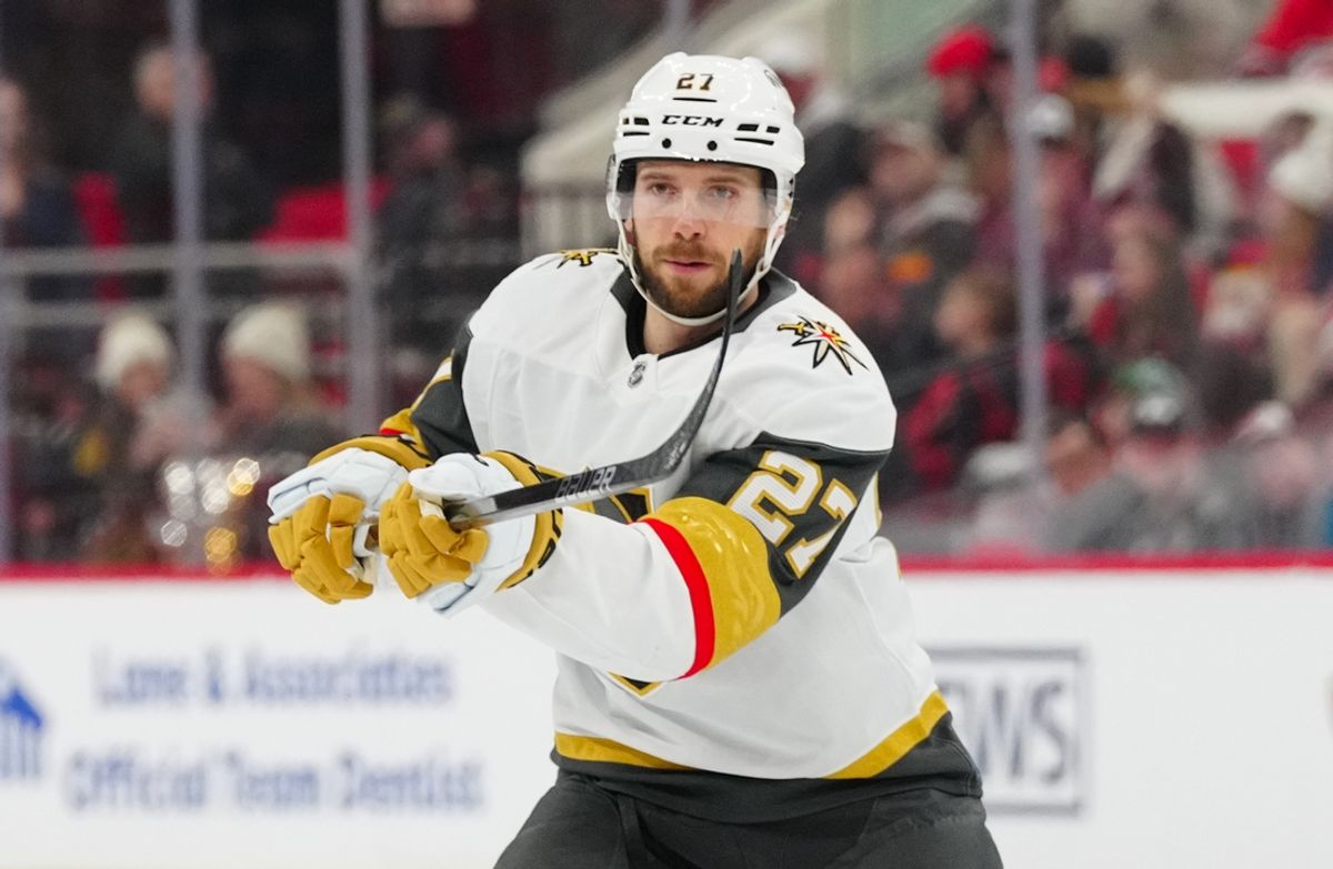 Jan 17, 2025; Raleigh, North Carolina, USA; Vegas Golden Knights defenseman Shea Theodore (27) watches his pass against the Carolina Hurricanes during the second period at Lenovo Center. Mandatory Credit: James Guillory-Imagn Images