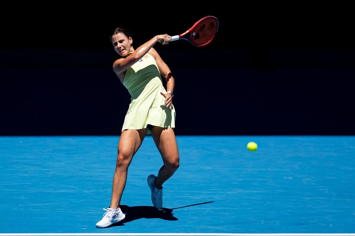 Jan 18, 2025; Melbourne, Victoria, Australia; Emma Navarro of United States of America hits a forehand during her match against Ons Jabeur of Tunisia in the third round of the women's singles at the 2025 Australian Open at Melbourne Park. Mandatory Credit: Mike Frey-Imagn Images