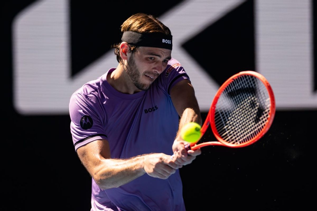 Jan 18, 2025; Melbourne, Victoria, Australia; Taylor Fritz of United States of America plays a backhand during his match against Gael Monfils of France in the third round of the men's singles at the 2025 Australian Open at Melbourne Park. Mandatory Credit: Mike Frey-Imagn Images