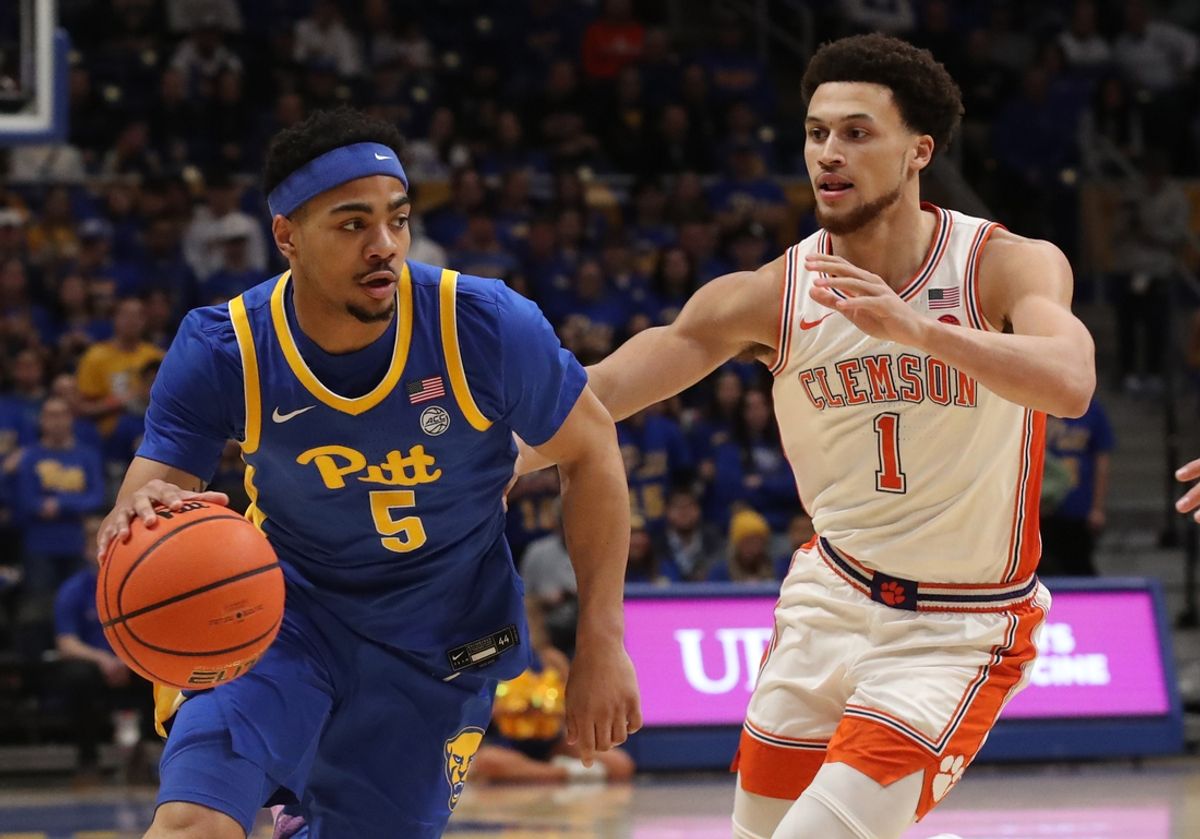 Jan 18, 2025; Pittsburgh, Pennsylvania, USA; Pittsburgh Panthers guard Ishmael Leggett (5) drives to the basket against Clemson Tigers guard Chase Hunter (1) during the first half at the Petersen Events Center. Mandatory Credit: Charles LeClaire-Imagn Images