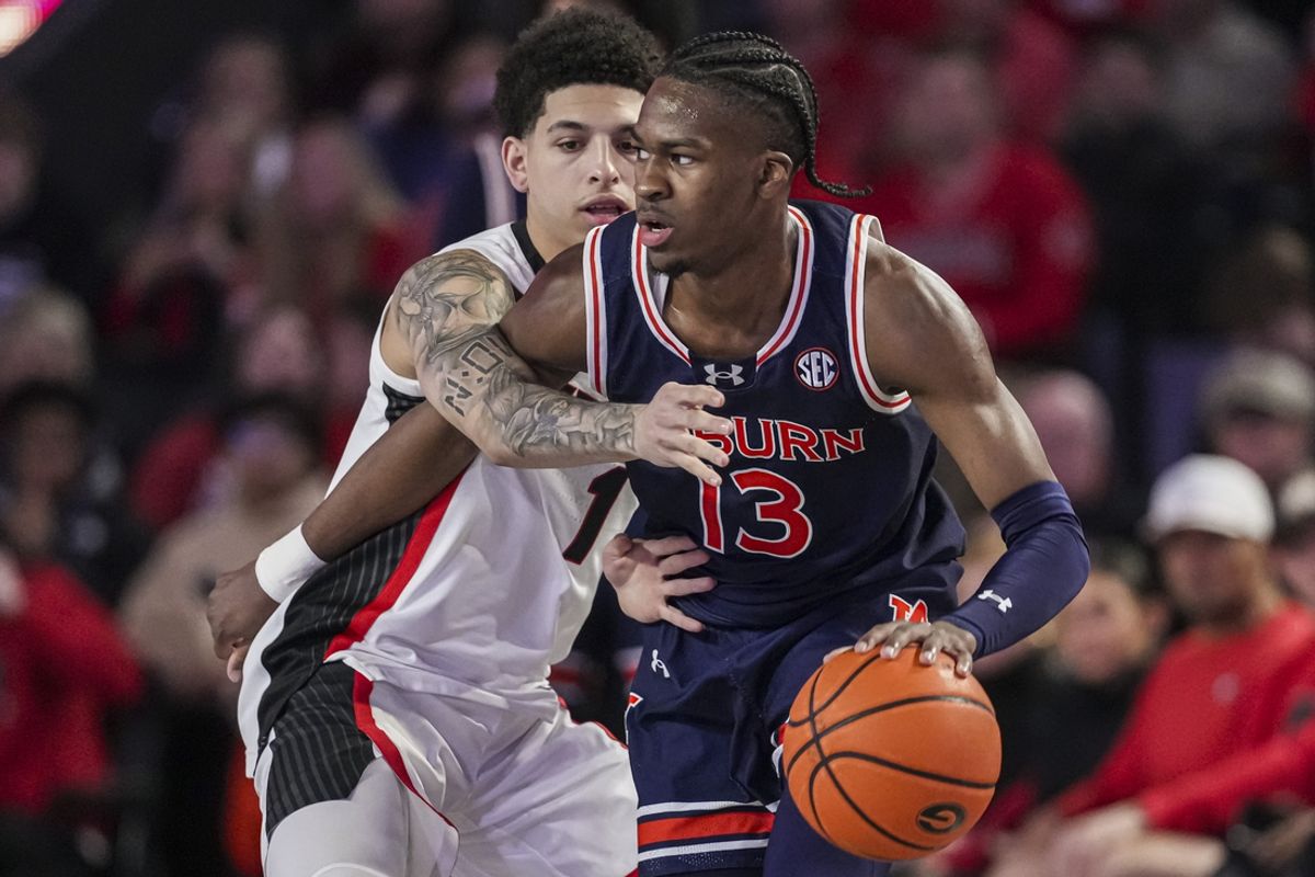 Jan 18, 2025; Athens, Georgia, USA; Auburn Tigers guard Miles Kelly (13) dribbles guarded by Georgia Bulldogs guard Dakota Leffew (1) during the first half at Stegeman Coliseum. Mandatory Credit: Dale Zanine-Imagn Images