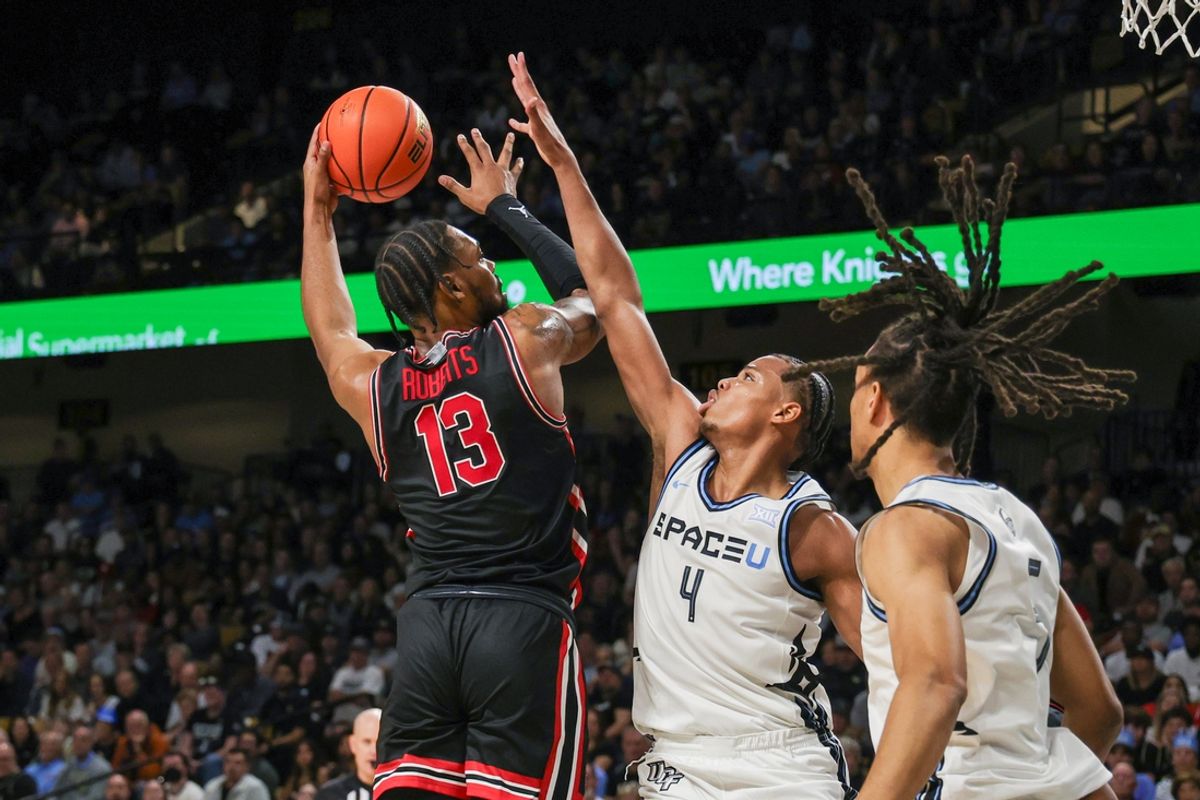 Jan 18, 2025; Orlando, Florida, USA; Houston Cougars forward J'Wan Roberts (13) is fouled by UCF Knights guard Keyshawn Hall (4) during the second half at Addition Financial Arena. Mandatory Credit: Mike Watters-Imagn Images