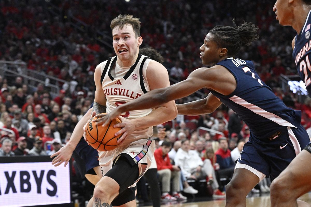 Jan 18, 2025; Louisville, Kentucky, USA;  Louisville Cardinals guard Reyne Smith (6) drives to the basket against Virginia Cavaliers guard Dai Dai Ames (7) during the second half at KFC Yum! Center. Louisville defeated Virginia 81-67. Mandatory Credit: Jamie Rhodes-Imagn Images