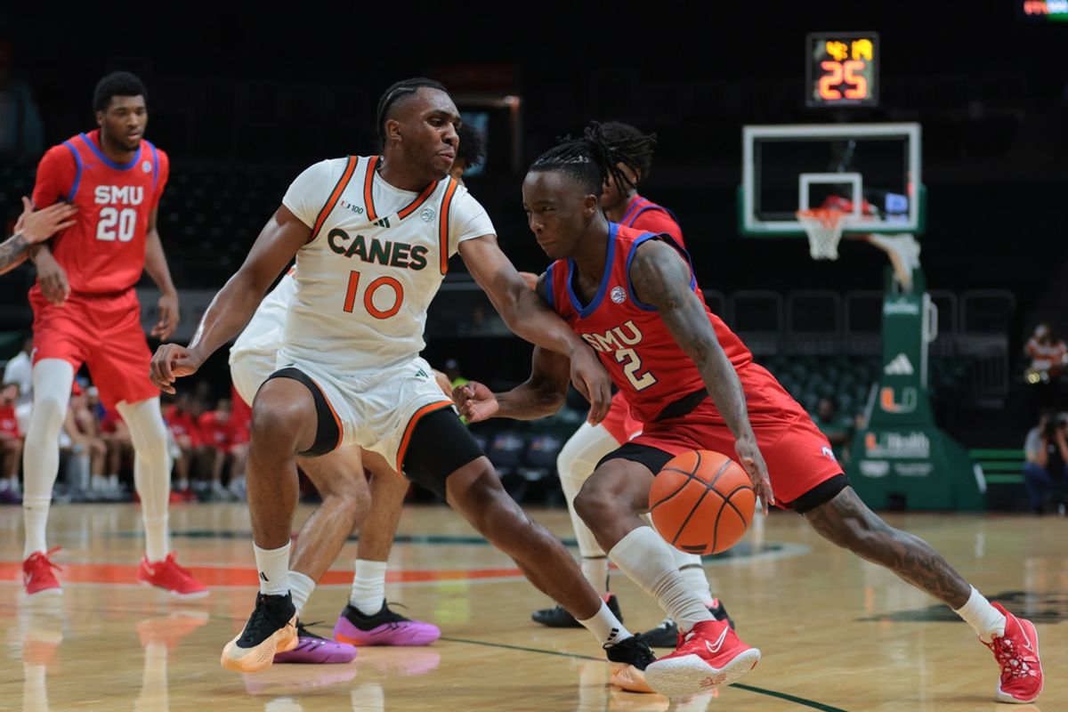 Jan 18, 2025; Coral Gables, Florida, USA; Southern Methodist Mustangs guard Boopie Miller (2) drives to the basket past Miami Hurricanes guard Paul Djobet (10) during the first half at Watsco Center. Mandatory Credit: Sam Navarro-Imagn Images