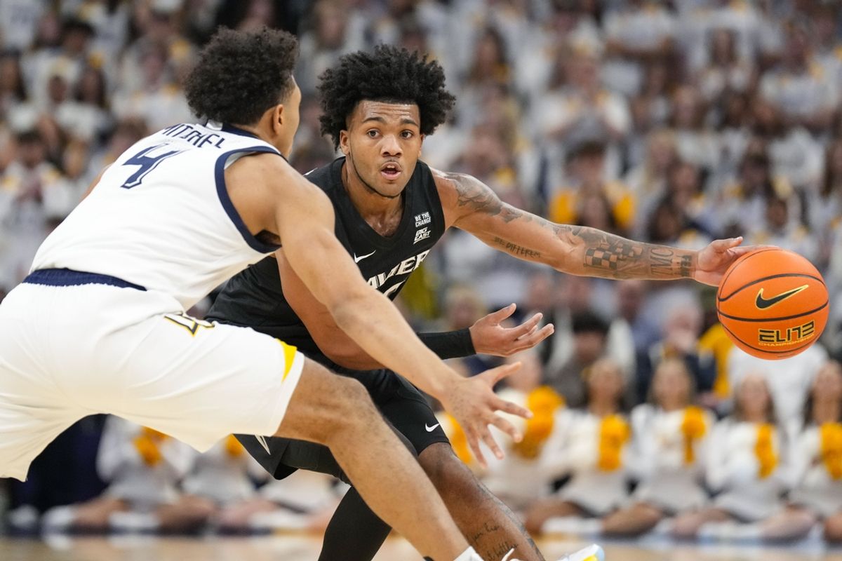 Jan 18, 2025; Milwaukee, Wisconsin, USA;  Xavier Musketeers guard Dayvion McKnight (20) looks to pass the ball around Marquette Golden Eagles guard Stevie Mitchell (4) during the first half at Fiserv Forum. Mandatory Credit: Jeff Hanisch-Imagn Images