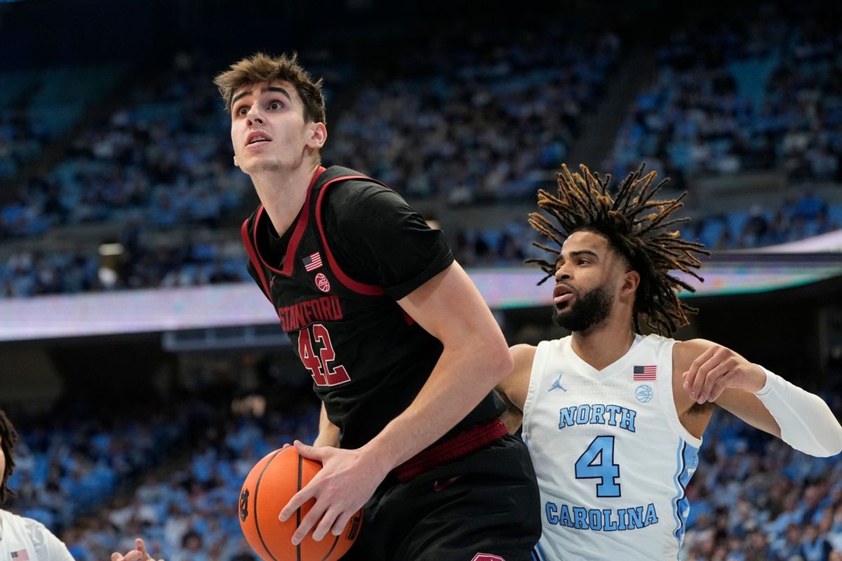 Jan 18, 2025; Chapel Hill, North Carolina, USA; Stanford Cardinal forward Maxime Raynaud (42) with the ball as North Carolina Tar Heels guard RJ Davis (4) defends in the first half at Dean E. Smith Center. Mandatory Credit: Bob Donnan-Imagn Images
