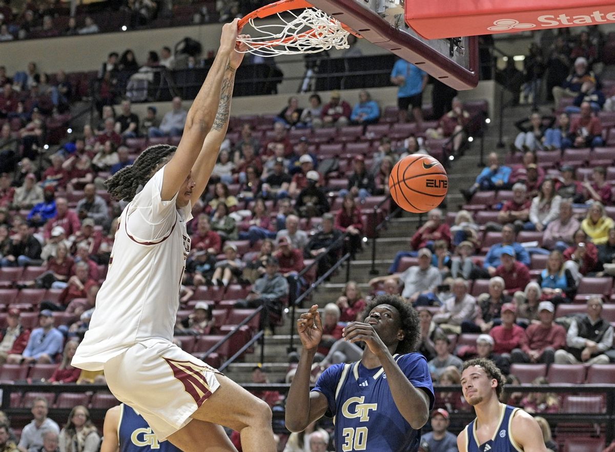 Jan 18, 2025; Tallahassee, Florida, USA; Florida State Seminoles forward Malique Ewin (12) dunks the ball against the Georgia Tech Yellowjackets during the second half at Donald L. Tucker Center. Mandatory Credit: Robert Myers-Imagn Images