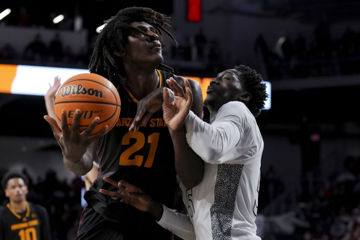 Jan 18, 2025; Cincinnati, Ohio, USA;  Arizona State Sun Devils forward Jayden Quaintance (21) drives to the basket as he is fouled by Cincinnati Bearcats forward Aziz Bandaogo (55) in the second half at Fifth Third Arena. Mandatory Credit: Aaron Doster-Imagn Images