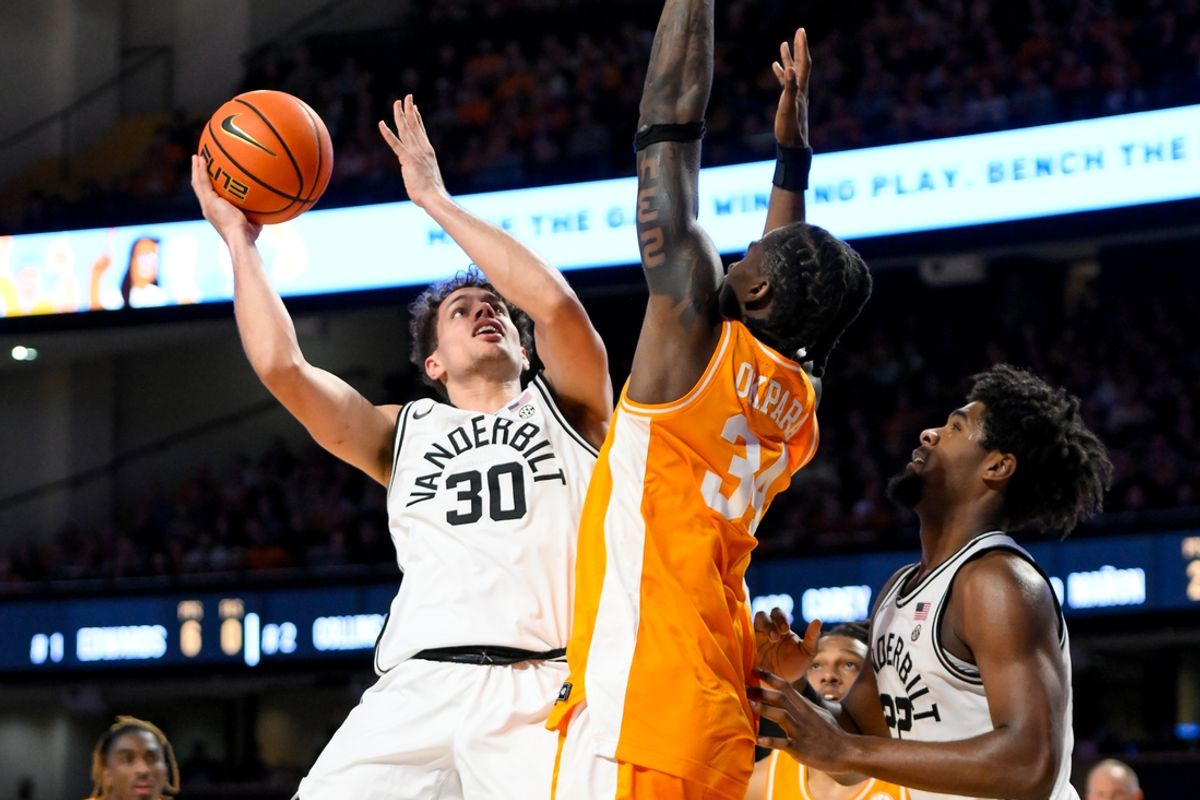 Jan 18, 2025; Nashville, Tennessee, USA;  Vanderbilt Commodores guard Chris Manon (30) shoots over Tennessee Volunteers forward Felix Okpara (34) during the first half at Memorial Gymnasium. Mandatory Credit: Steve Roberts-Imagn Images