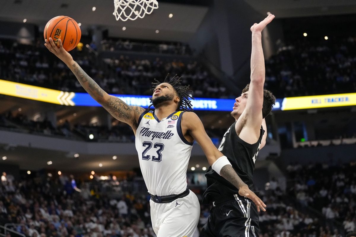 Jan 18, 2025; Milwaukee, Wisconsin, USA;  Marquette Golden Eagles forward David Joplin (23) shoots around Xavier Musketeers forward Zach Freemantle (32) during the second half at Fiserv Forum. Mandatory Credit: Jeff Hanisch-Imagn Images