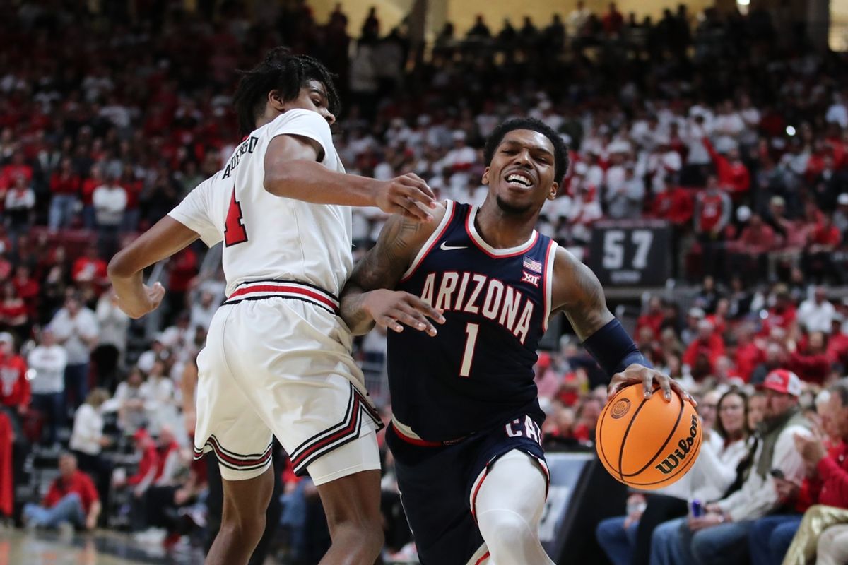 Jan 18, 2025; Lubbock, Texas, USA; Arizona Wildcats guard Caleb Love (1) reacts after being blocked by Texas Tech Red Raiders guard Christian Anderson (4) in the first half at United Supermarkets Arena. Mandatory Credit: Michael C. Johnson-Imagn Images