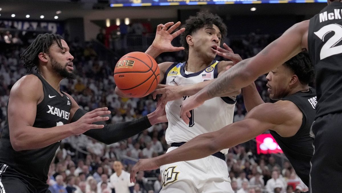 Xavier guard Marcus Foster swats the ball away from Marquette guard Stevie Mitchell (4) during the first half of their game Saturday, January 18, 2025 at Fiserv Forum in Milwaukee, Wisconsin.