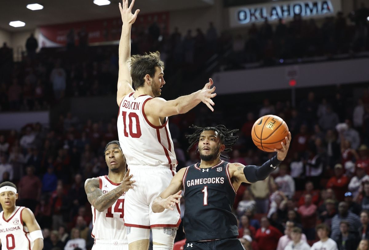 Jan 18, 2025; Norman, Oklahoma, USA; South Carolina Gamecocks guard Jacobi Wright (1) passes around Oklahoma Sooners forward Sam Godwin (10) during the first half at Lloyd Noble Center. Mandatory Credit: Alonzo Adams-Imagn Images