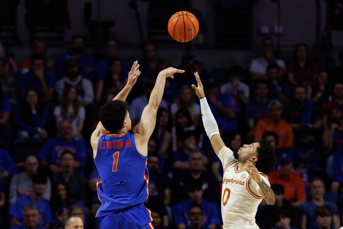 Jan 18, 2025; Gainesville, Florida, USA; Texas Longhorns guard Jordan Pope (0) attempts to block a shot from Florida Gators guard Walter Clayton Jr. (1) during the first half at Exactech Arena at the Stephen C. O'Connell Center. Mandatory Credit: Matt Pendleton-Imagn Images