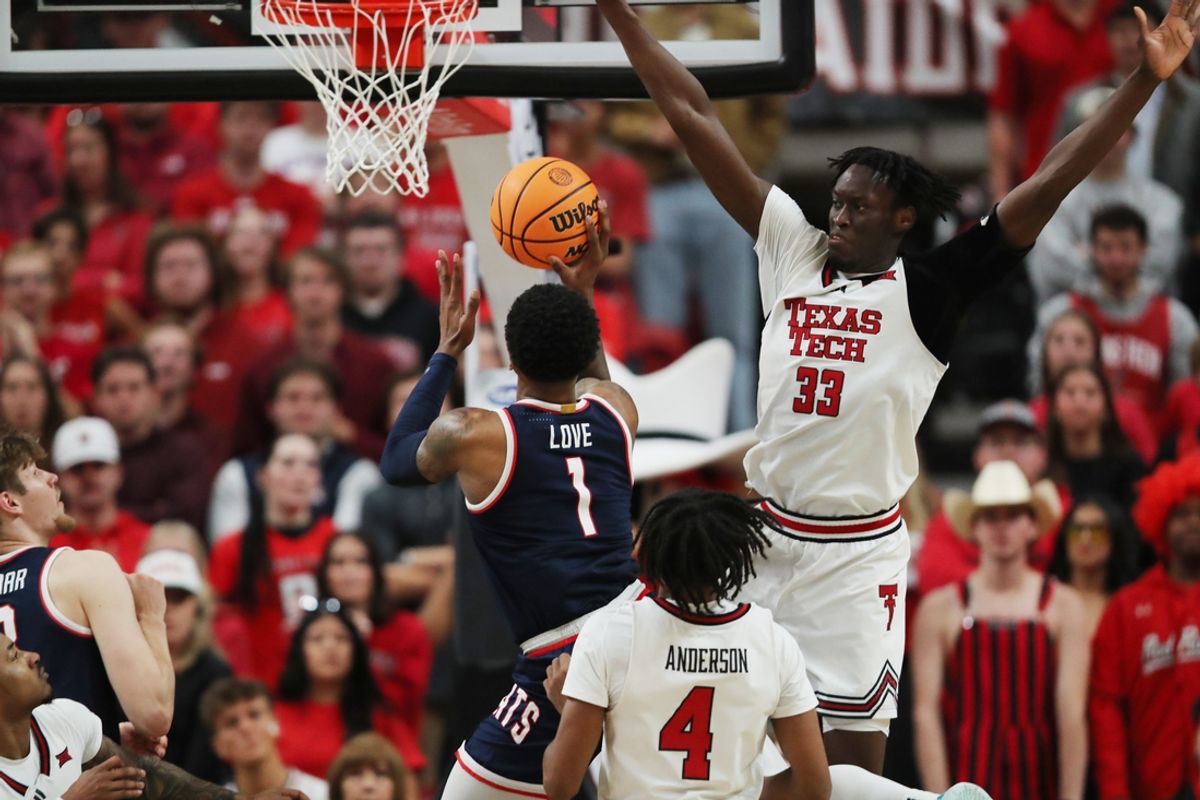 Jan 18, 2025; Lubbock, Texas, USA;  Arizona Wildcats guard Caleb Love (1) shoots against Texas Tech Red Raiders forward Federiko Federiko (33) in the second half at United Supermarkets Arena. Mandatory Credit: Michael C. Johnson-Imagn Images