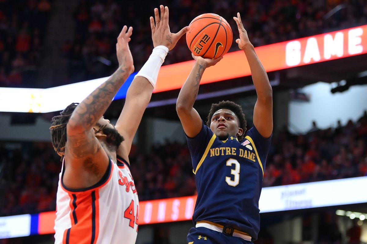 Jan 18, 2025; Syracuse, New York, USA; Notre Dame Fighting Irish guard Markus Burton (3) shoots against Syracuse Orange center Eddie Lampkin Jr. (44) during the second half at the JMA Wireless Dome. Mandatory Credit: Rich Barnes-Imagn Images