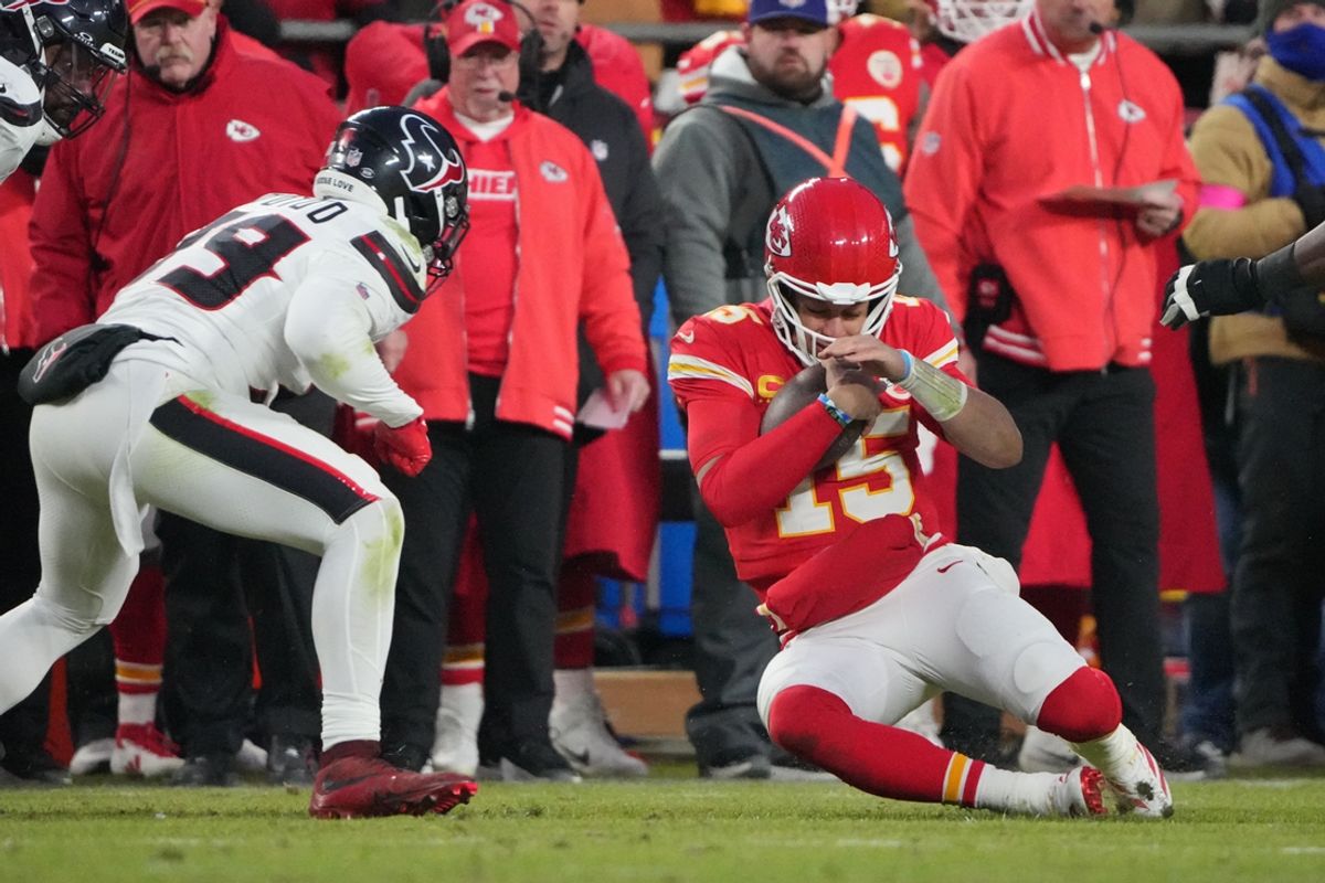 Jan 18, 2025; Kansas City, Missouri, USA; Kansas City Chiefs quarterback Patrick Mahomes (15) slides against Houston Texans linebacker Henry To'oTo'o (39) during the fourth quarter of a 2025 AFC divisional round game at GEHA Field at Arrowhead Stadium. Mandatory Credit: Denny Medley-Imagn Images