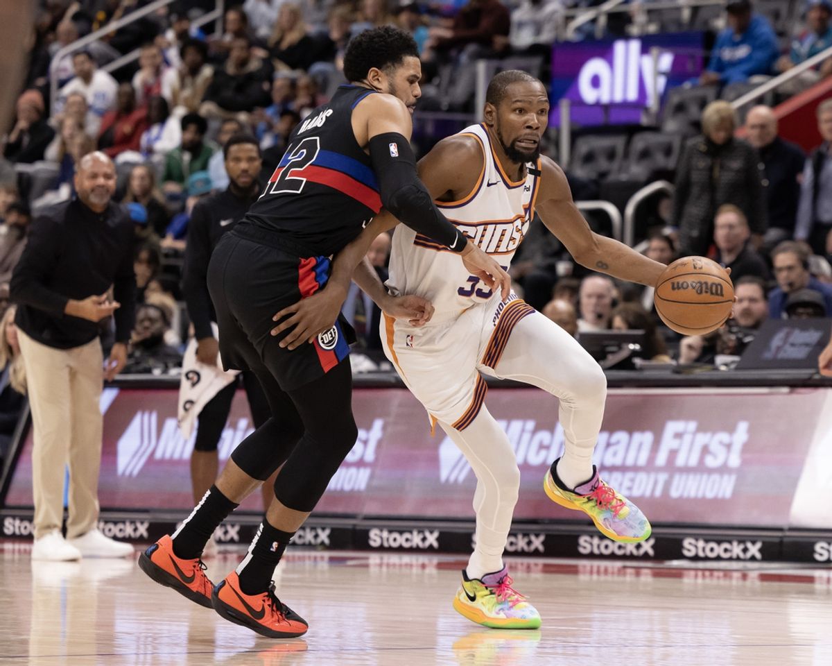 Jan 18, 2025; Detroit, Michigan, USA; Detroit Pistons forward Tobias Harris (12) defends against Phoenix Suns forward Kevin Durant (35) during the fourth quarter at Little Caesars Arena. Mandatory Credit: David Reginek-Imagn Images