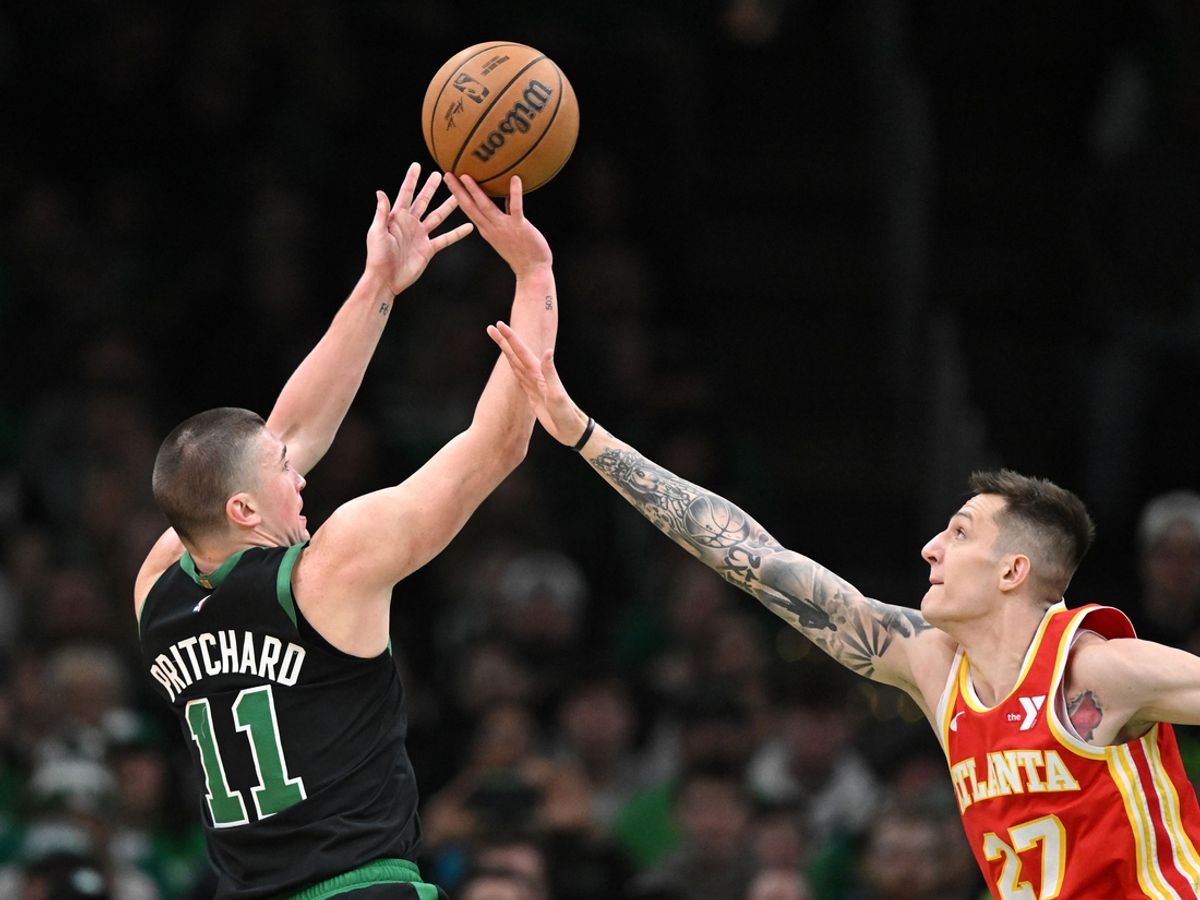 Jan 18, 2025; Boston, Massachusetts, USA; Boston Celtics guard Payton Pritchard (11) attempts a three-point basket against Atlanta Hawks guard Vit Krejci (27) during the second quarter at the TD Garden. Mandatory Credit: Brian Fluharty-Imagn Images