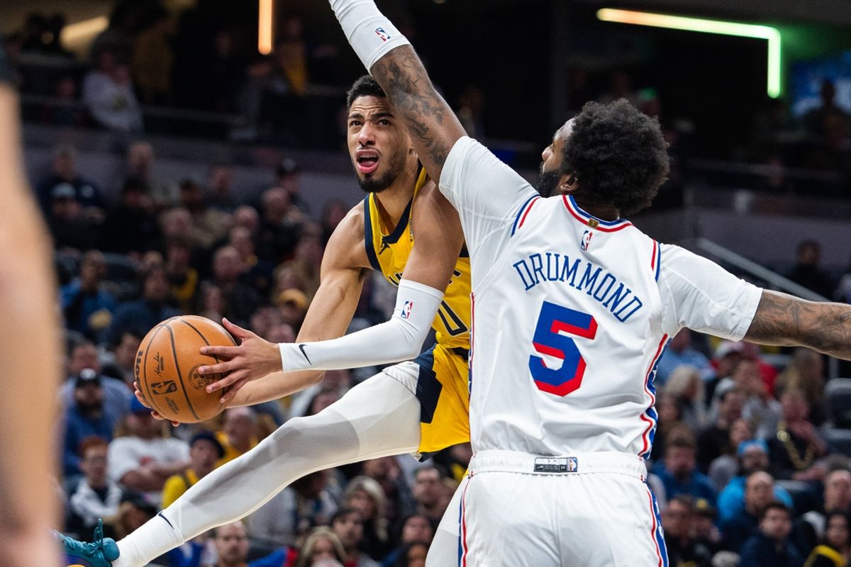 Jan 18, 2025; Indianapolis, Indiana, USA; Indiana Pacers guard Tyrese Haliburton (0) shoots the ball while Philadelphia 76ers center Andre Drummond (5) defends in the first half at Gainbridge Fieldhouse. Mandatory Credit: Trevor Ruszkowski-Imagn Images